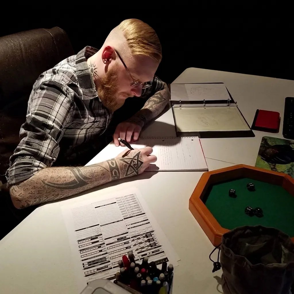 A dedicated writer lost in creative flow, intently scribbling ideas into an open notebook while surrounded by a colorful assortment of pens and markers scattered across the desk.